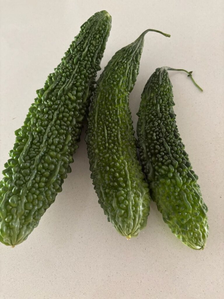 Three bitter gourds grown at Willetton Community Garden.